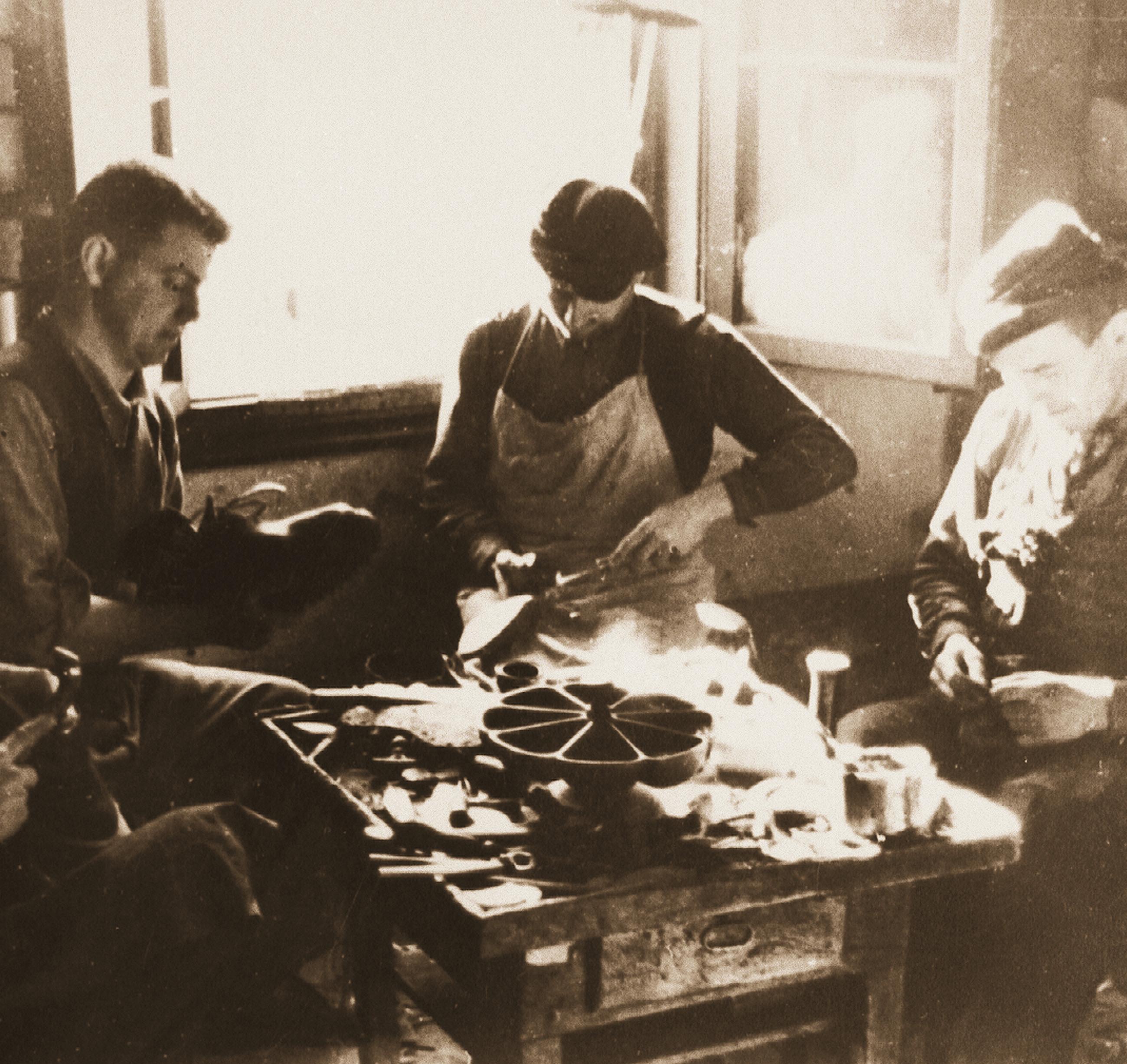 Old photograph of three men sitting and making Zamberlan boots by hand