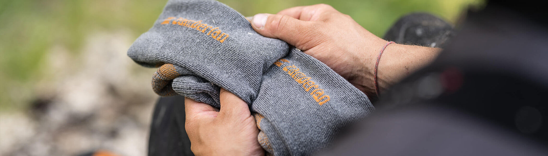 A person holding grey Zamberlan socks. 
